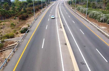 Where should vehicles drive in a road divided by a Central divider?